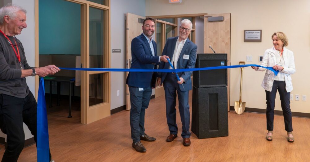 Haven Executive Director Will Towne and former ED Michael Redmond cut the ceremonial ribbon, held by Board President Kathy Welling and VP Jim Zien